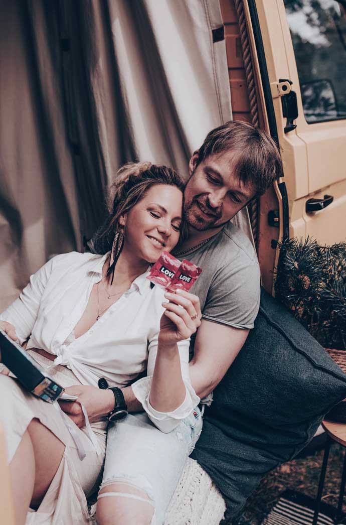 Couple relaxing together with conversation cards from Because Love Should Be an Action