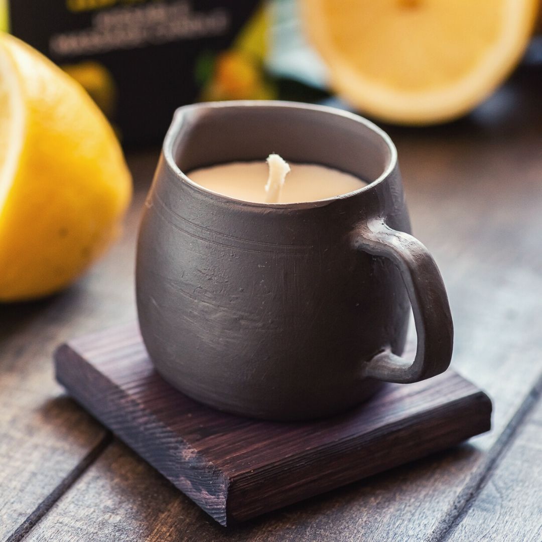 Edible massage oil candle in black pottery